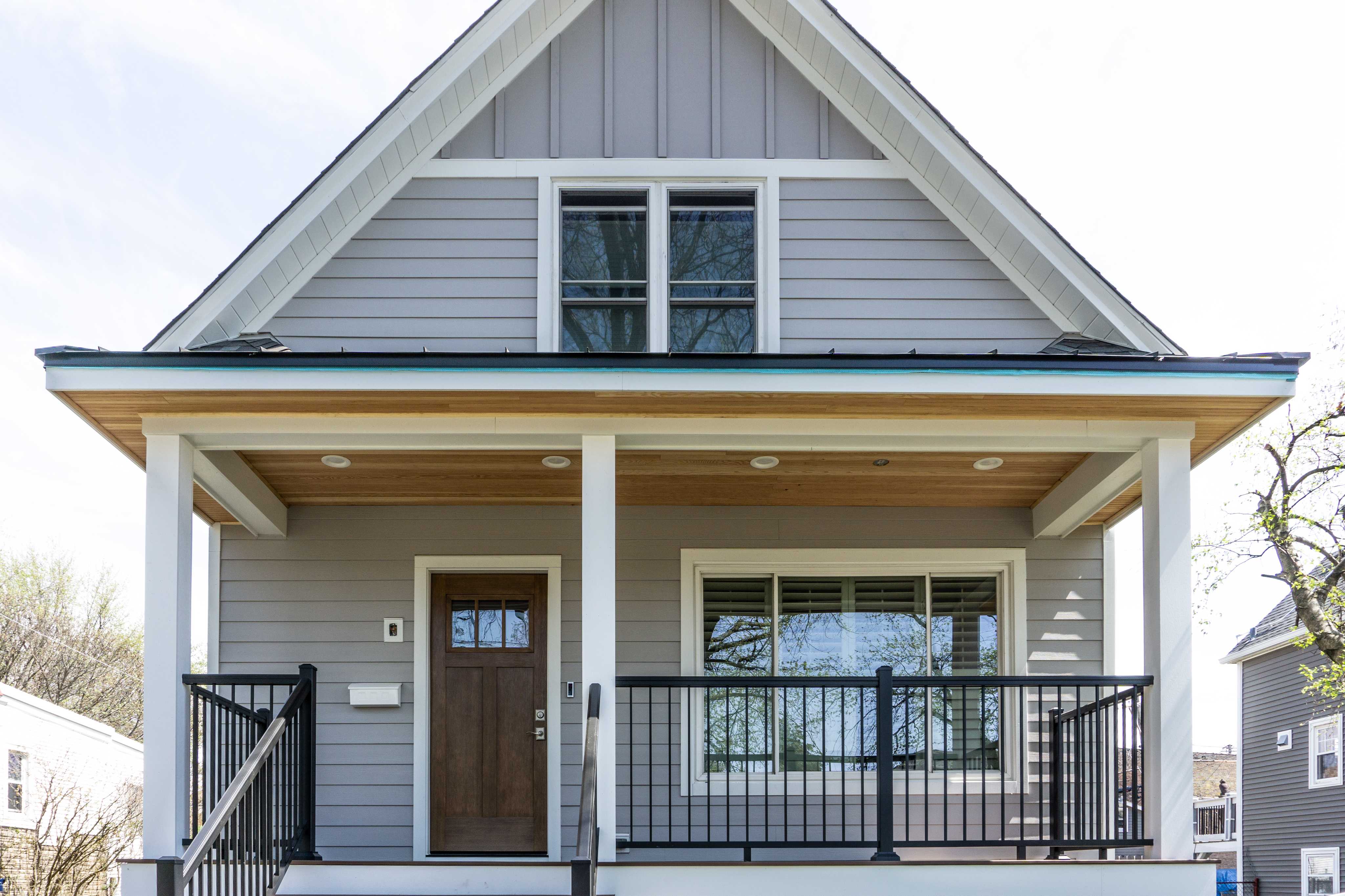 Hardie siding and custom porch installation on a Chicago farmhouse